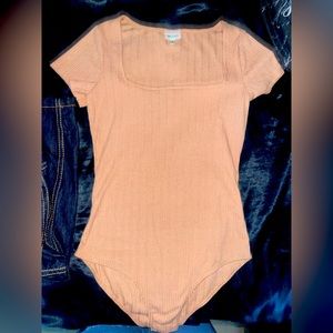 Tan bodysuit , medium size.